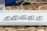 Options of wrap rings: moon and stars, mountains and moon and stars, mountains and forest, mountains and sun and birds, and waves and sun and birds